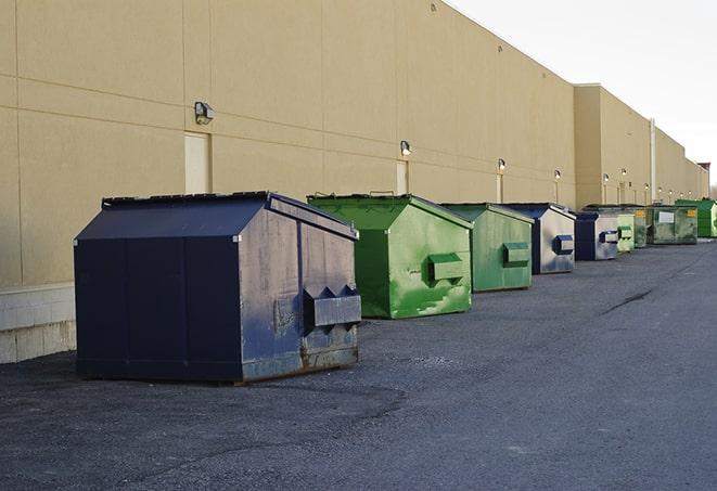 construction crew disposing of building materials in large bins in Alexandria TN